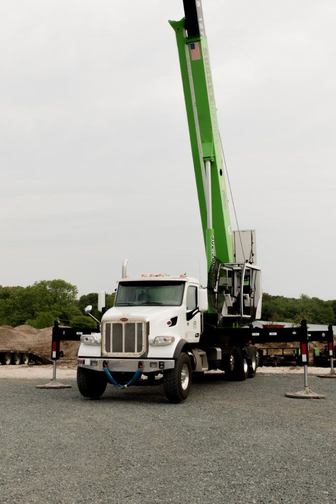 White Truck with Green Crane attached