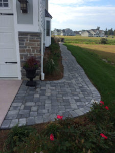 finished stone pathway on side of house with garden
