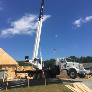 Crane moving to and grabbing another piece of framework
