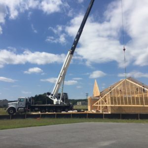 Crane grabbing third piece of framework for final touches