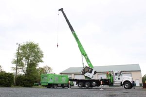 Large crane mounted on white truck